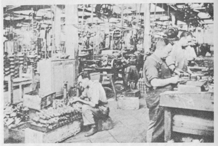 “Workers in a large collectivized factory shifted to the production of war material.”