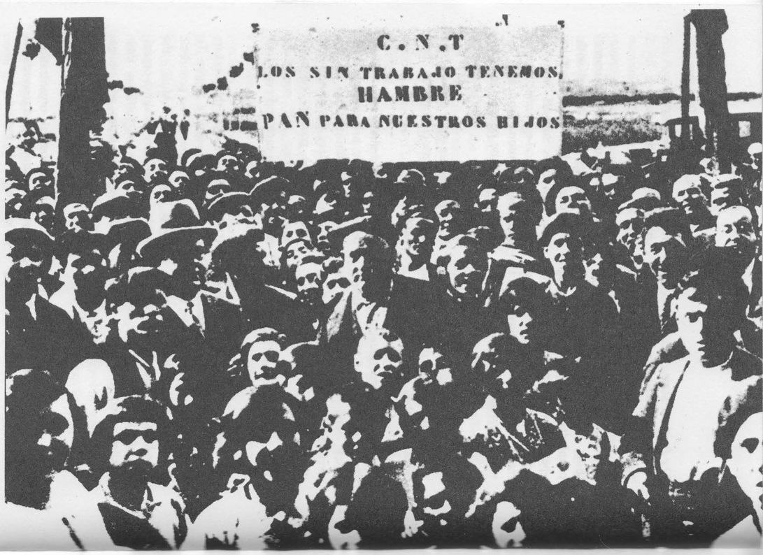 “A mass demonstration of the CNT in 1931. The banner proclaims, ‘The unemployed are starving. Bread for our children!’”
